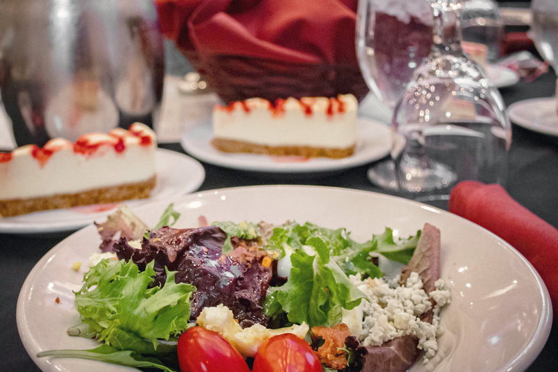 A composed salad plate with sliced tomatoes and dressed greens.