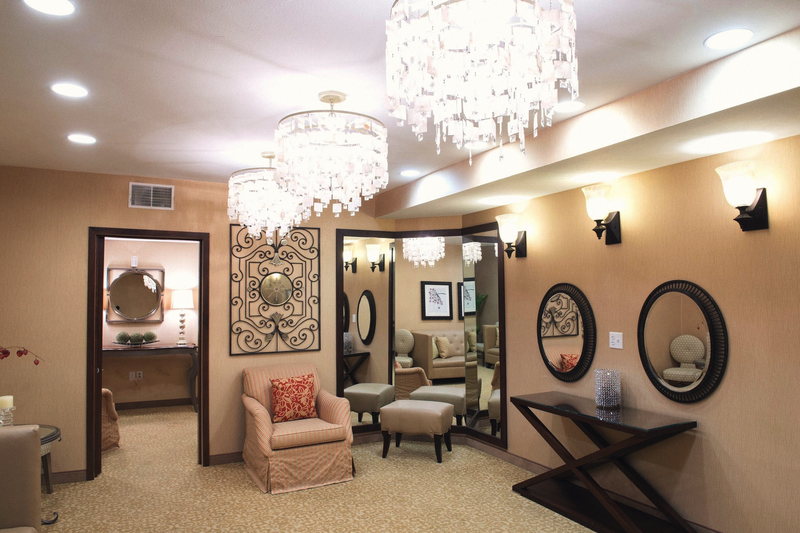 The Bridal Suite, empty, with chandeliers, wall mirrors and a settee.