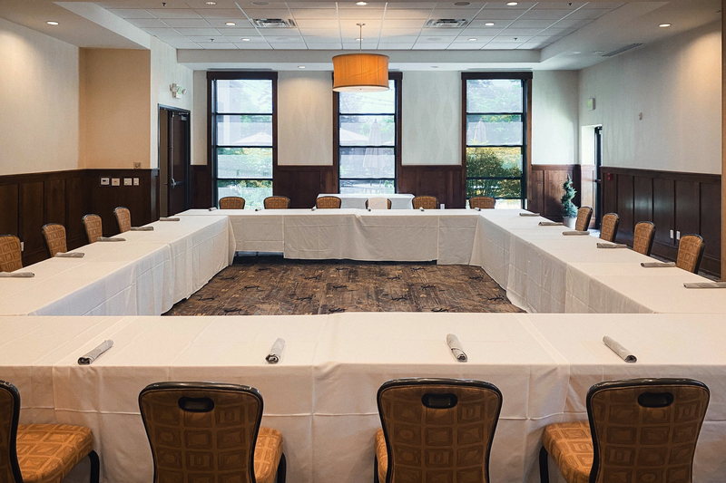 The Maple room set in a hollow square, with wainscot panelling and daylight from two western windows.